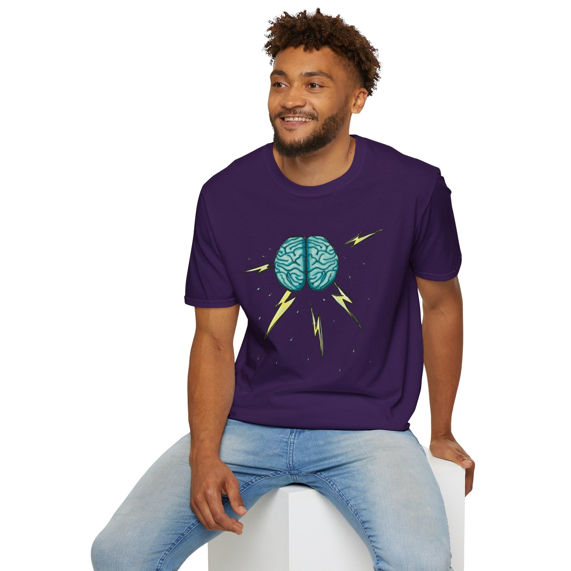 Man wearing a purple unisex short sleeve tee featuring an illustration of a brain with lightning bolts and rain pouring from it, giving a literal twist to the term "brainstorm"—because sometimes, even the best ideas need a little weathering!