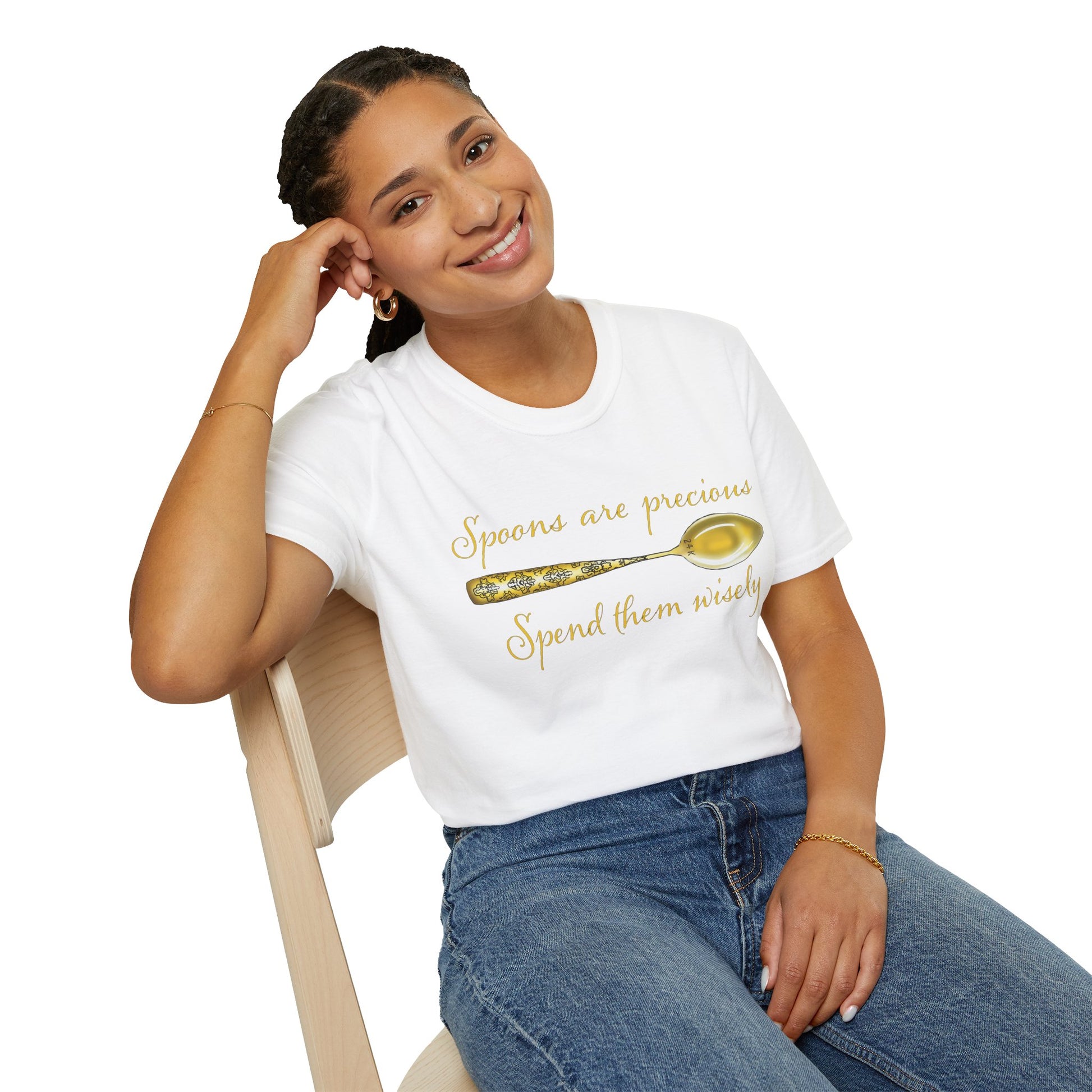 Woman wearing a white t-shirt featuring a picture of a gold spoon and the phrase 'Spoons are precious, spend them wisely.'