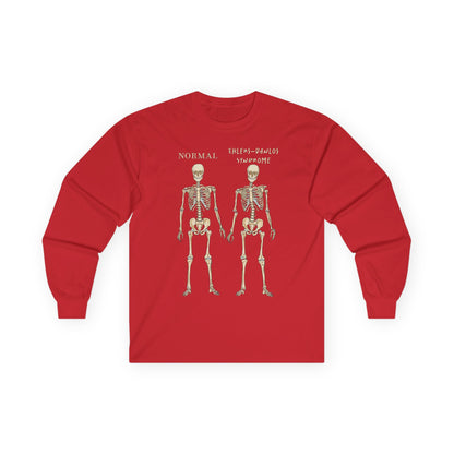 A red long sleeve shirt with two skeletons side by side—one labeled "normal," the other "Ehlers-Danlos Syndrome"—visually showcasing the effects of EDS with a clever, anatomy-inspired twist.