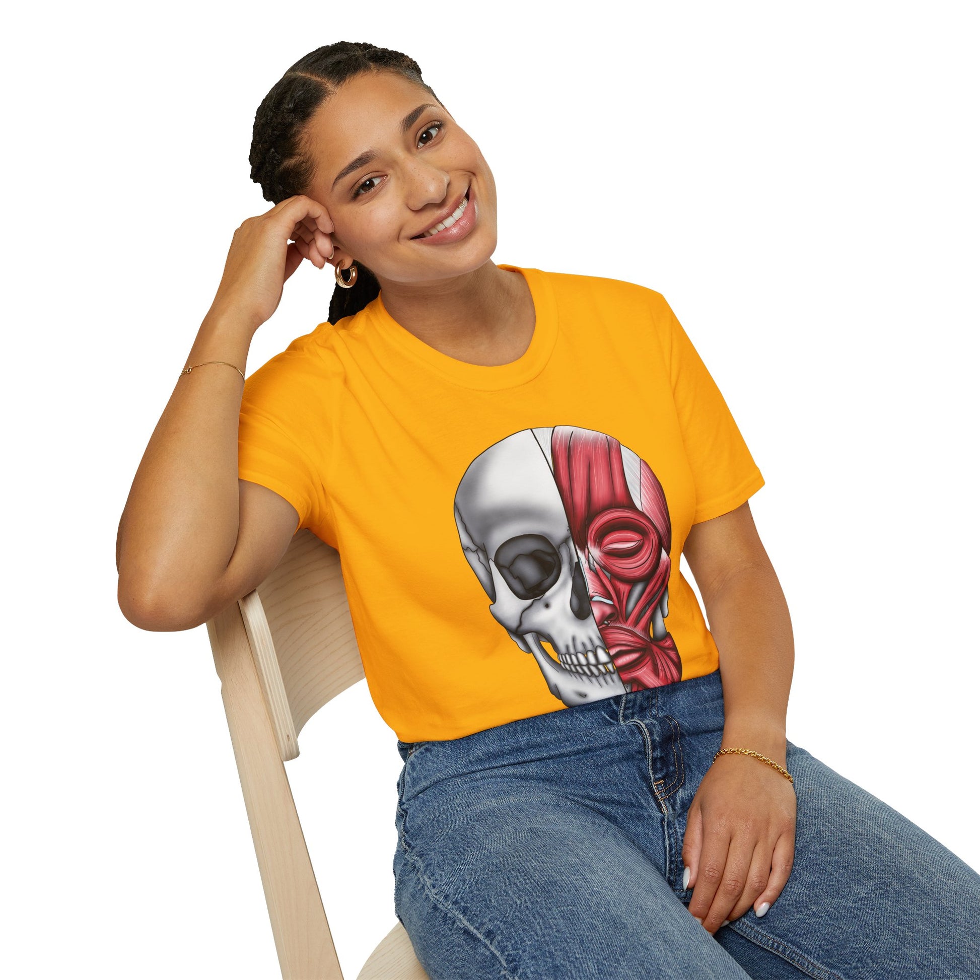 Woman wearing a yellow shirt featuring an anatomically correct skull illustration, with half of the skull covered by facial muscles.