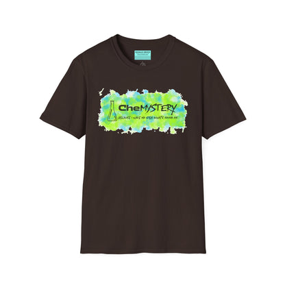Brown short-sleeve unisex t-shirt with playful watercolor-style blue and green splotches, a simple line-drawn beaker, and the witty phrase “CheMystery: because I have no idea what’s going on”—perfect for anyone who’s ever been personally victimized by the periodic table.