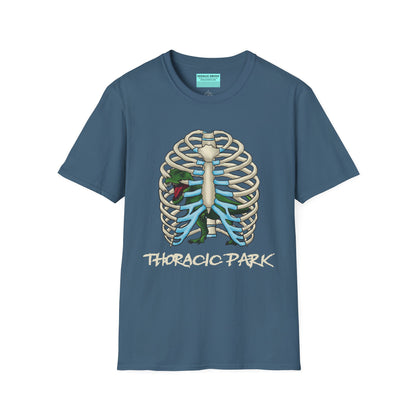 Indigo blue unisex short sleeve tee with a clever Jurassic twist—an anatomical rib cage doubles as a prehistoric prison for a tiny T-Rex, with the punny caption "Thoracic Park" below. It's dino-mite meets anatomy class in the best way possible.
