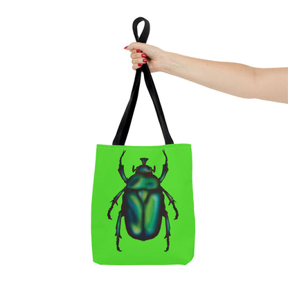 Small lime green tote bag with a black handle in a woman’s hand held out to the side featuring an illustration of a June bug (green chafer beetle).