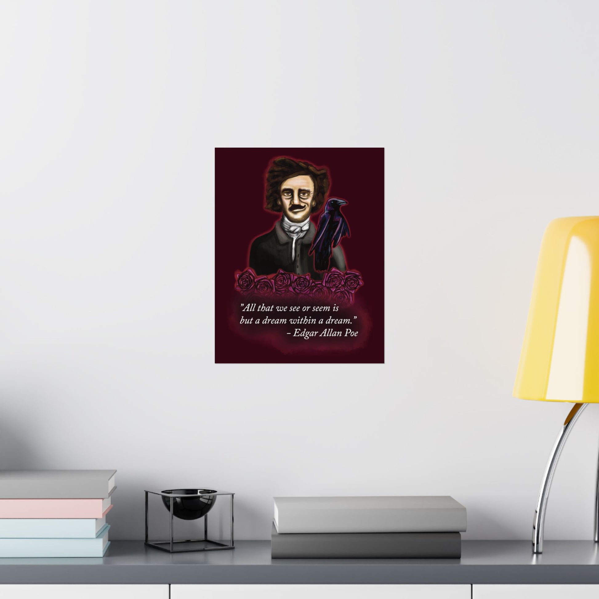 A small moody poster of Edgar Allan Poe hung in an office setting. He is wearing a wry smile as he’s surrounded by crimson roses and a raven, with a rich burgundy background—because even the master of macabre has a soft spot for gothic romance.