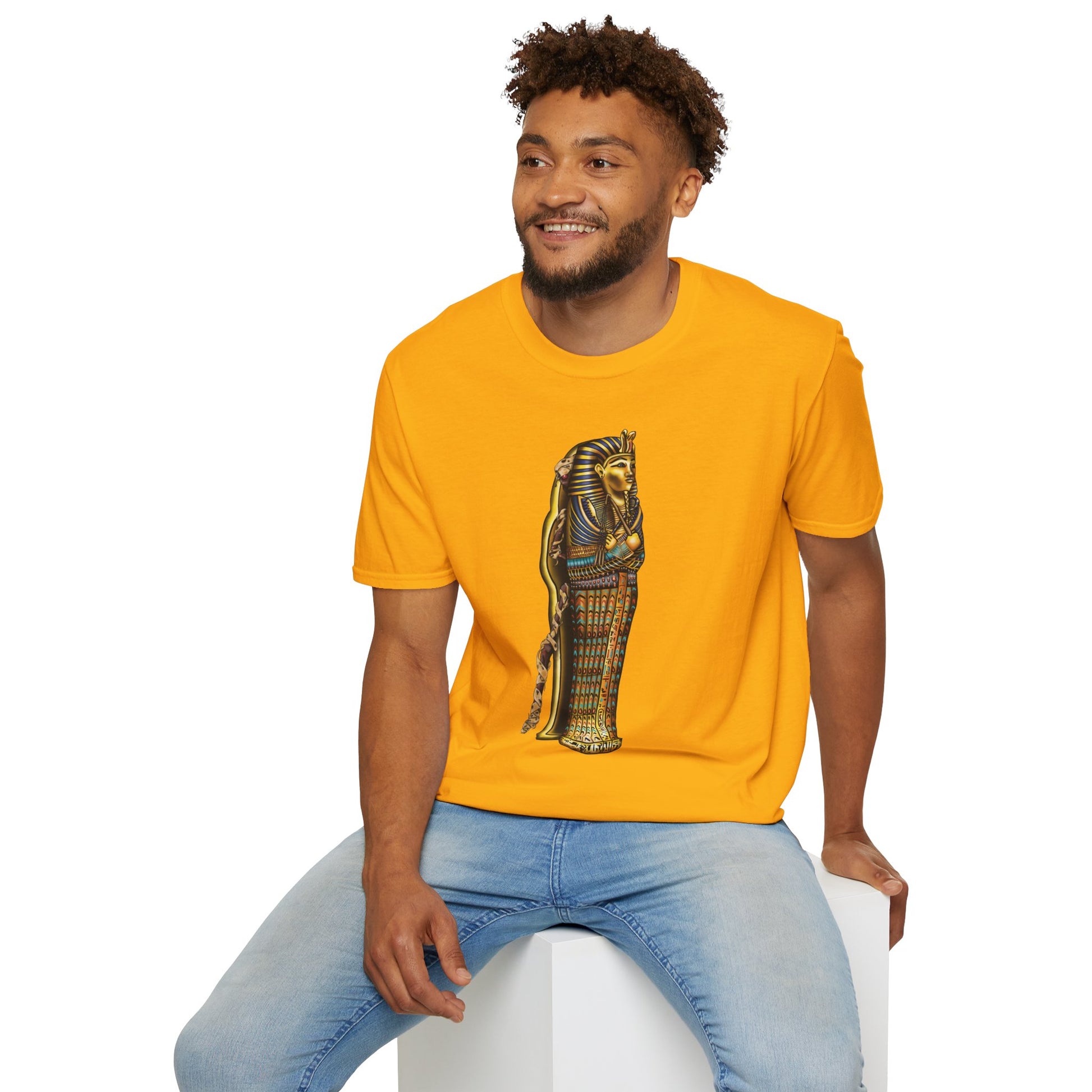 Man wearing a yellow t-shirt featuring an illustration of an Egyptian sarcophagus, with a mummy stepping out of it and glowing red eyes.