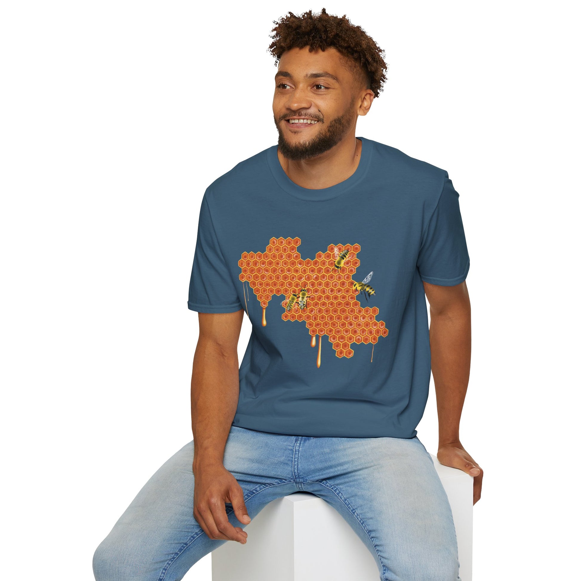 Man wearing a blue shirt featuring a picture of honeybees buzzing around a large piece of honeycomb with honey dripping down from it.
