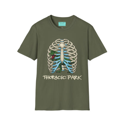 Military green unisex short sleeve tee with a clever Jurassic twist—an anatomical rib cage doubles as a prehistoric prison for a tiny T-Rex, with the punny caption "Thoracic Park" below. It's dino-mite meets anatomy class in the best way possible.
