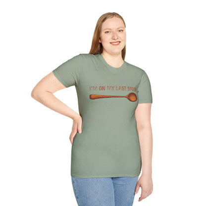 Woman wearing a green t-shirt with an illustration of a single wooden spoon and the phrase 'I'm on my last spoon' printed on the front.