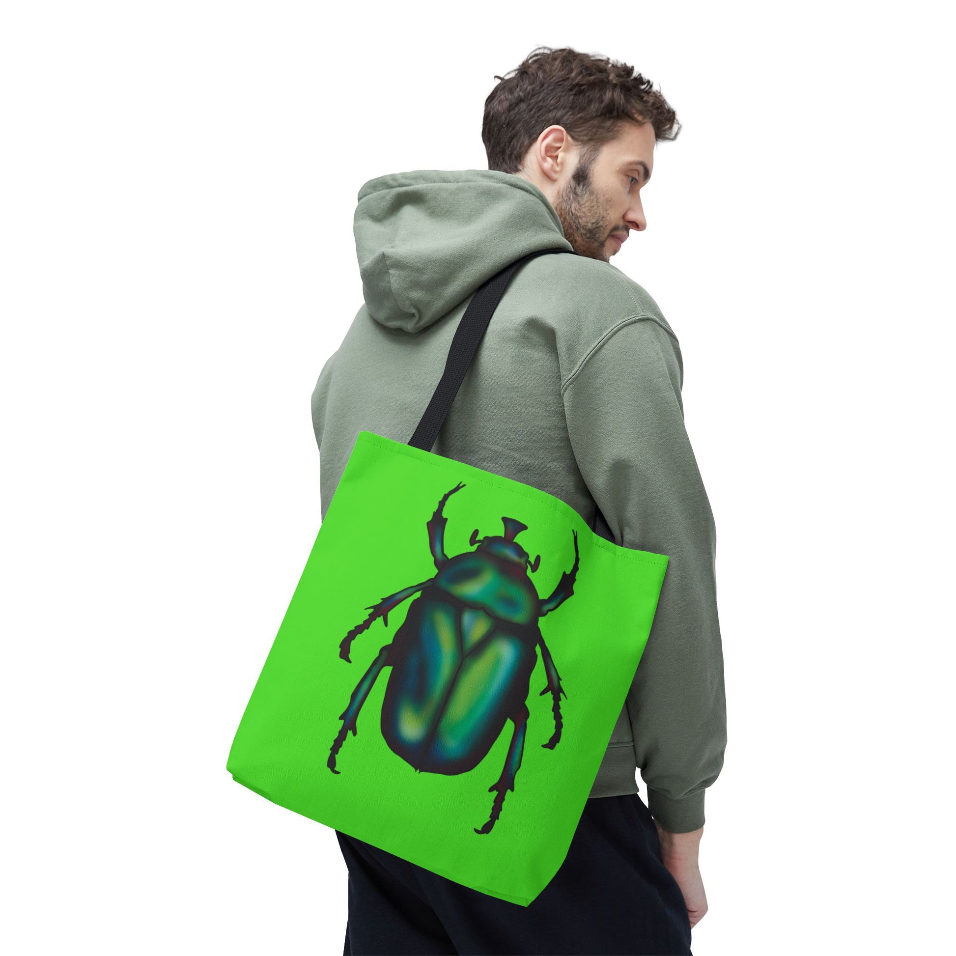 Medium lime green tote bag with a black handle on a man's shoulder featuring an illustration of a June bug (green chafer beetle).