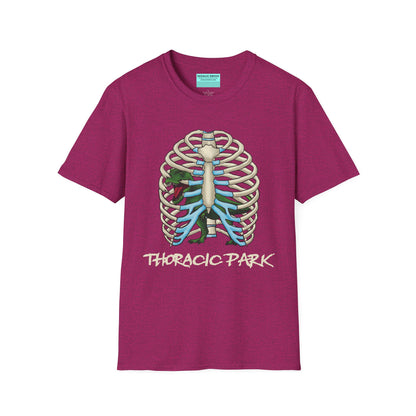 Pink unisex short sleeve tee with a clever Jurassic twist—an anatomical rib cage doubles as a prehistoric prison for a tiny T-Rex, with the punny caption "Thoracic Park" below. It's dino-mite meets anatomy class in the best way possible.