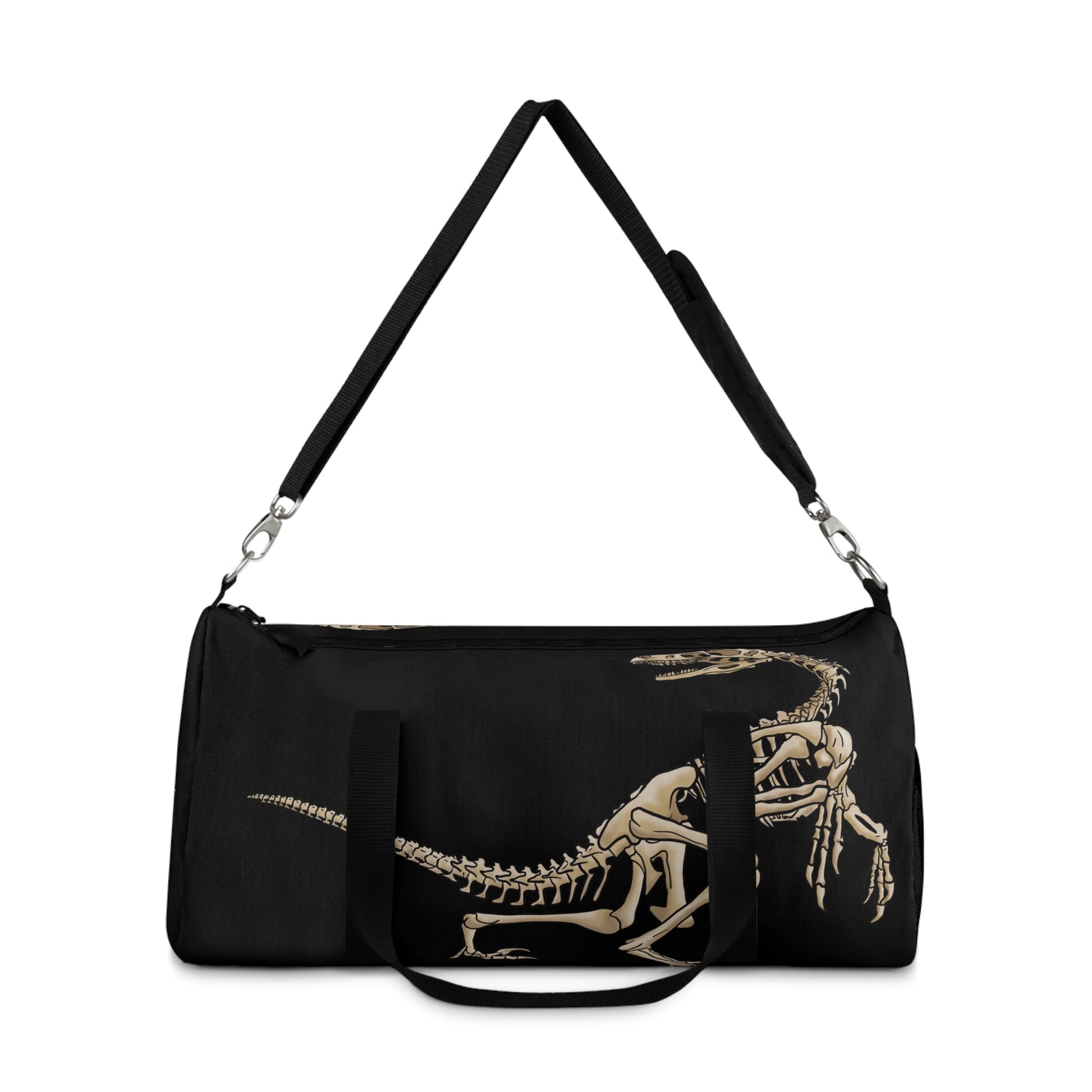 Front view of a black duffel bag with the shoulder strap lifted with bone-beige illustrations of velociraptor skeleton fossils—perfect for carrying your gear while channeling serious prehistoric predator energy.