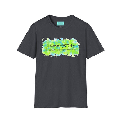 Dark grey short-sleeve unisex t-shirt with playful watercolor-style blue and green splotches, a simple line-drawn beaker, and the witty phrase “CheMystery: because I have no idea what’s going on”—perfect for anyone who’s ever been personally victimized by the periodic table.