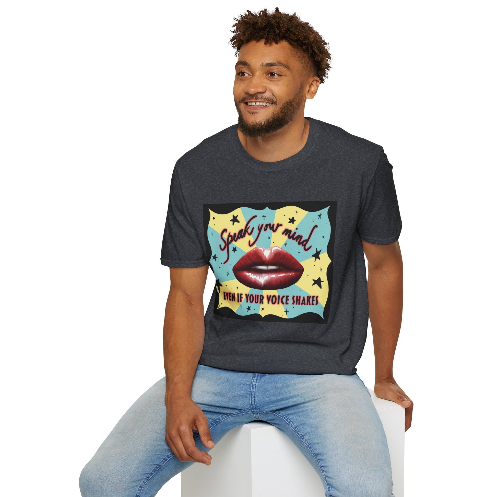 Man wearing a dark grey t-shirt featuring an illustration of red lips and the phrase 'Speak your mind, even if your voice shakes.'