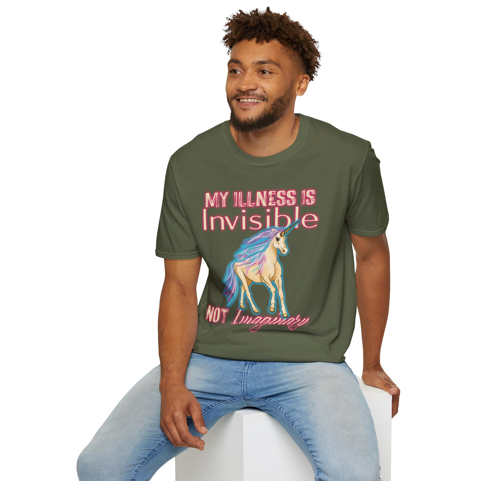 Man wearing a green shirt featuring a drawing of a unicorn and the phrase 'My illness is invisible not imaginary'.