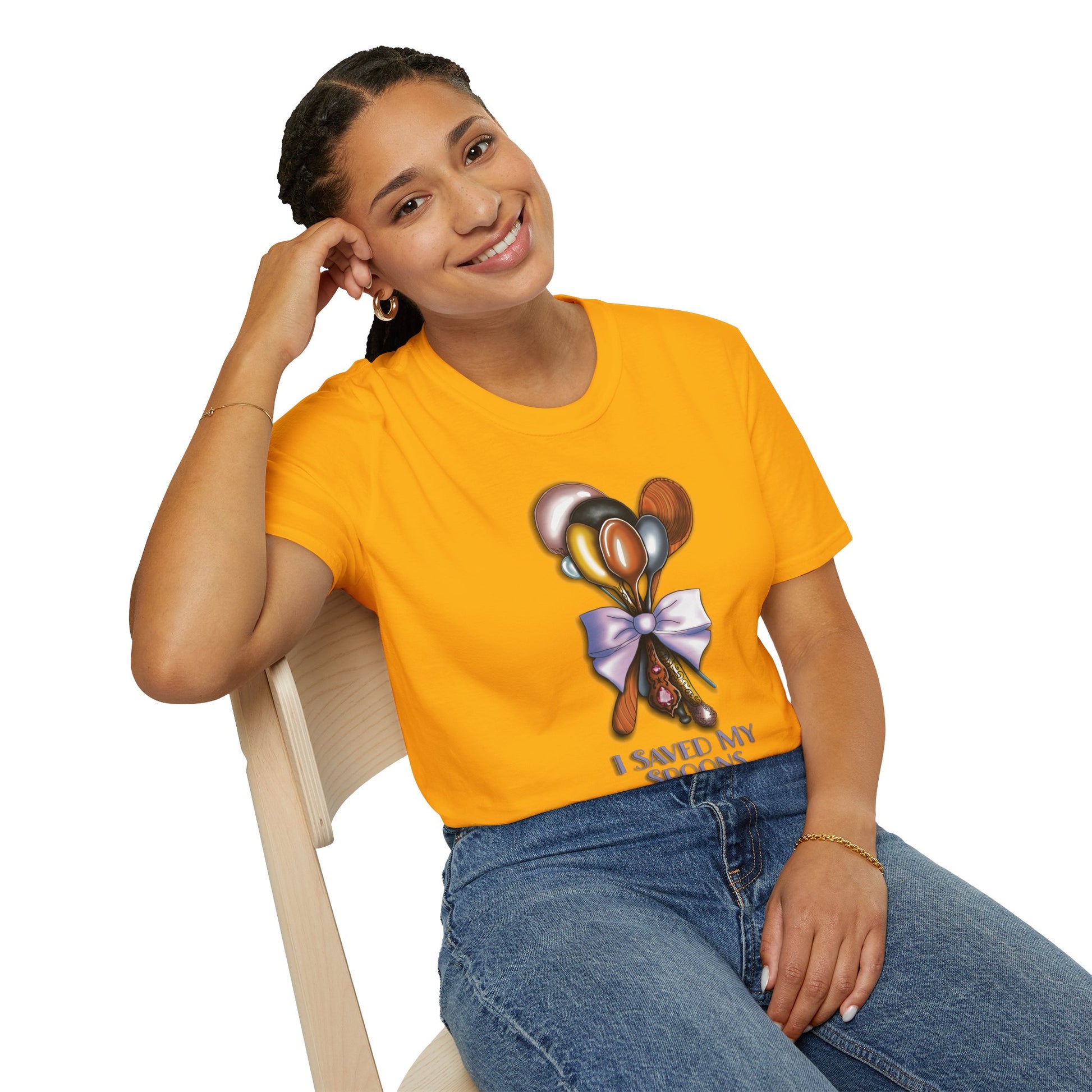 Woman wearing a yellow t-shirt featuring a bouquet of spoons illustration and the phrase 'I saved my spoons to be here' on the front.