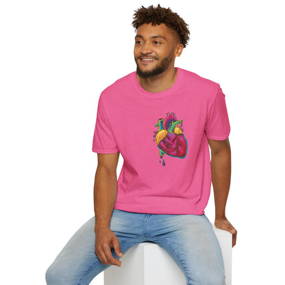 Man wearing a pink unisex short sleeve t-shirt featuring a bold neon anatomical heart front and off-center, complete with dripping blood vessels—because nothing says “wear your heart on your sleeve” like wearing it smack on your chest in highlighter tones.