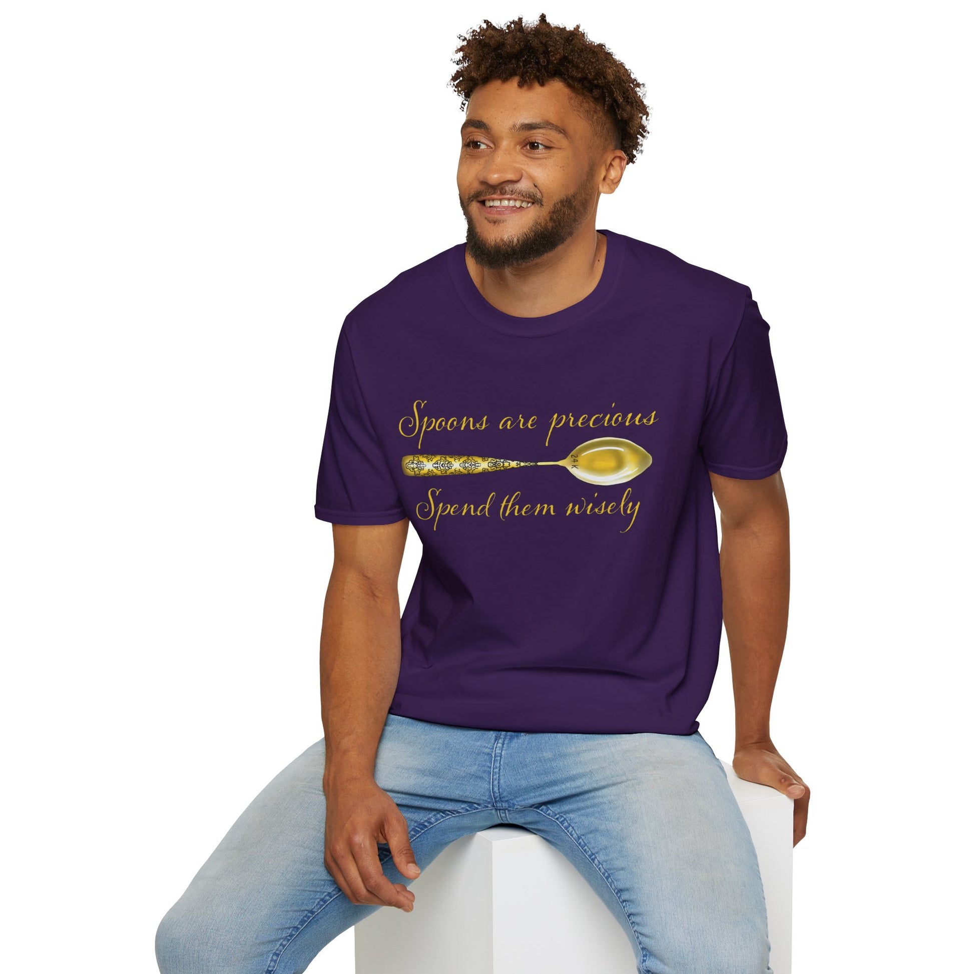 Man wearing a purple t-shirt featuring a picture of a gold spoon and the phrase 'Spoons are precious, spend them wisely.'