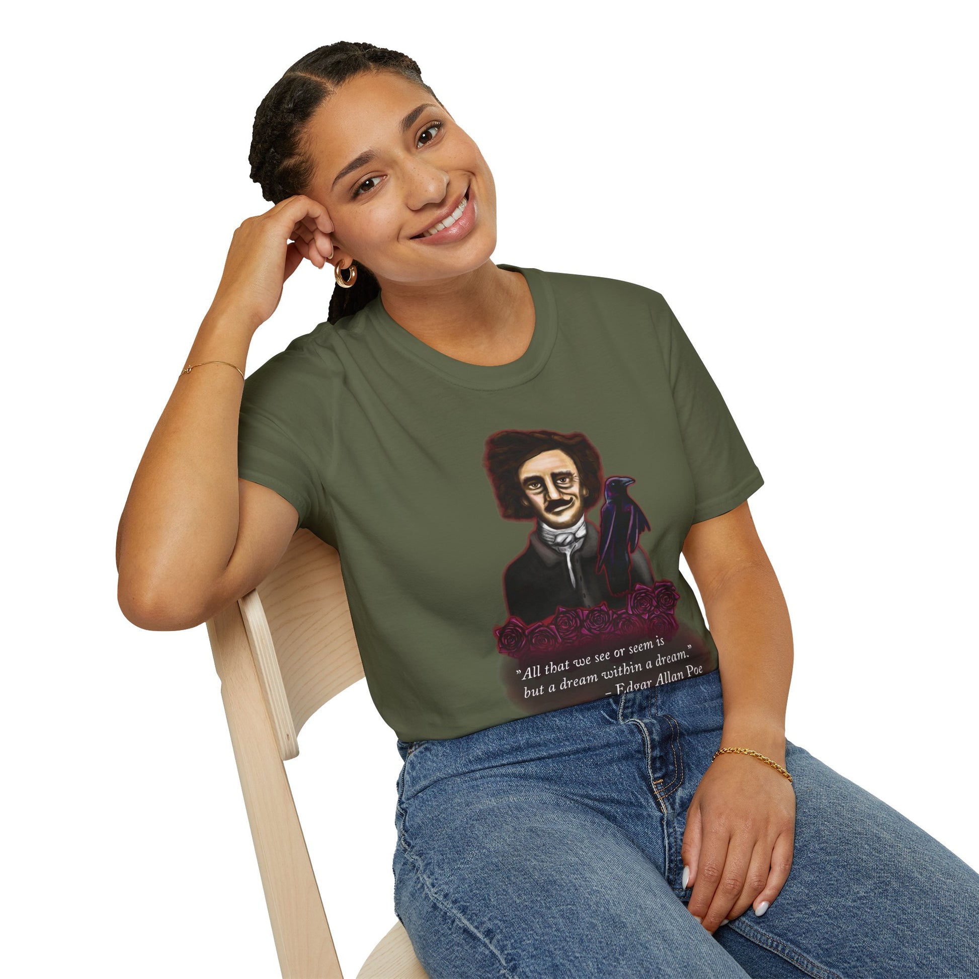 Woman wearing a green t-shirt featuring a drawing of Edgar Allan Poe with a raven perched nearby and red roses surrounding them, along with the quote 'All that we see or seem is but a dream within a dream.'
