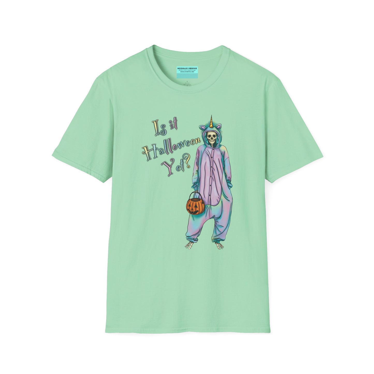 Mint green t-shirt featuring a drawing of a skeleton in a unicorn costume onesie, with the phrase 'Is it Halloween yet?' printed on it.
