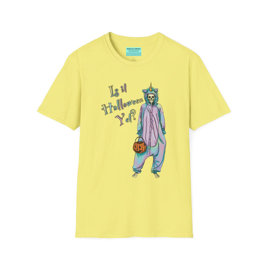 Yellow t-shirt featuring a drawing of a skeleton in a unicorn costume onesie, with the phrase 'Is it Halloween yet?' printed on it.