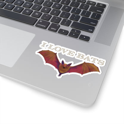 Medium sticker featuring a drawing of a brown bat in flight with text that says 'I love bats.' The sticker is adhered to a computer