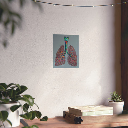 Small anatomical lungs poster hanging in a home, showing detailed illustrations of the bronchial tree, trachea, and larynx on a blue-grey background.