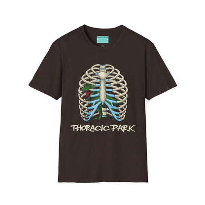 Brown unisex short sleeve tee with a clever Jurassic twist—an anatomical rib cage doubles as a prehistoric prison for a tiny T-Rex, with the punny caption "Thoracic Park" below. It's dino-mite meets anatomy class in the best way possible.