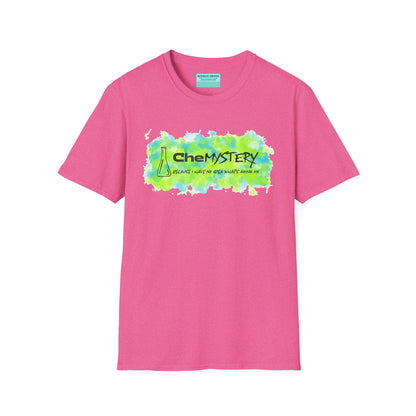Pink short-sleeve unisex t-shirt with playful watercolor-style blue and green splotches, a simple line-drawn beaker, and the witty phrase “CheMystery: because I have no idea what’s going on”—perfect for anyone who’s ever been personally victimized by the periodic table.