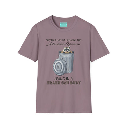 Purple t-shirt featuring an illustration of a raccoon in a metal trash can, with the phrase 'Chronic illness is like being this adorable raccoon living in a trash can body' printed on it.