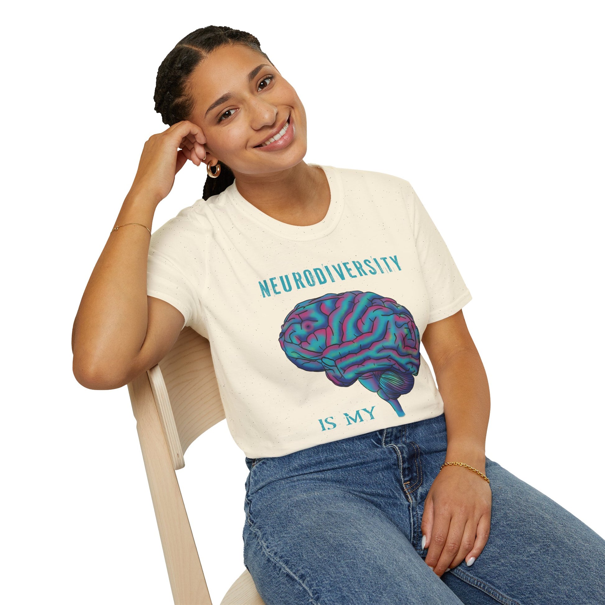 Woman wearing a beige t-shirt featuring an anatomical drawing of a brain, with the phrase 'Neurodiversity is my superpower' printed on it.