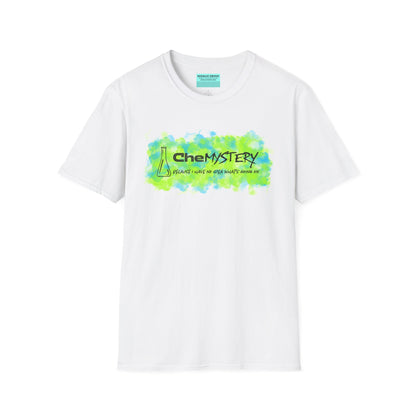 White short-sleeve unisex t-shirt with playful watercolor-style blue and green splotches, a simple line-drawn beaker, and the witty phrase “CheMystery: because I have no idea what’s going on”—perfect for anyone who’s ever been personally victimized by the periodic table.