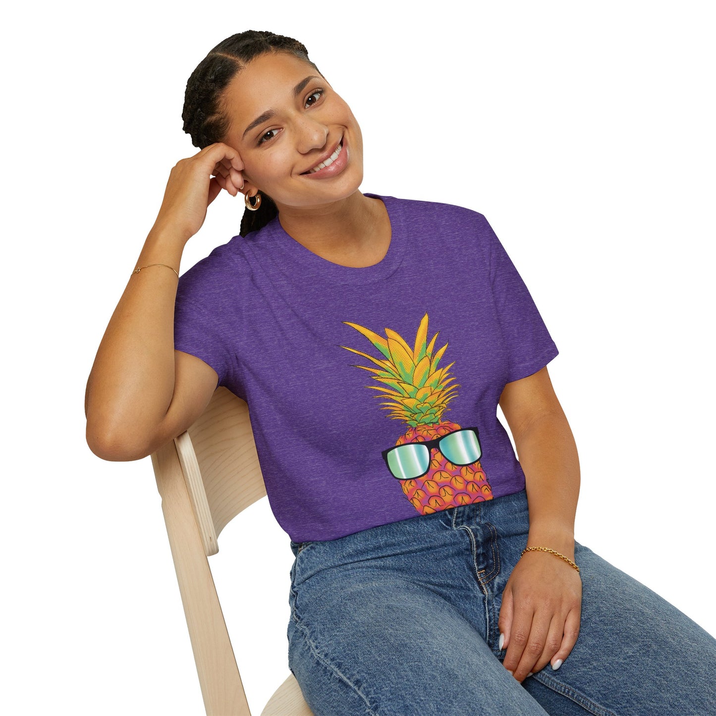 Woman wearing a purple t-shirt featuring a drawing of a pineapple wearing sunglasses.