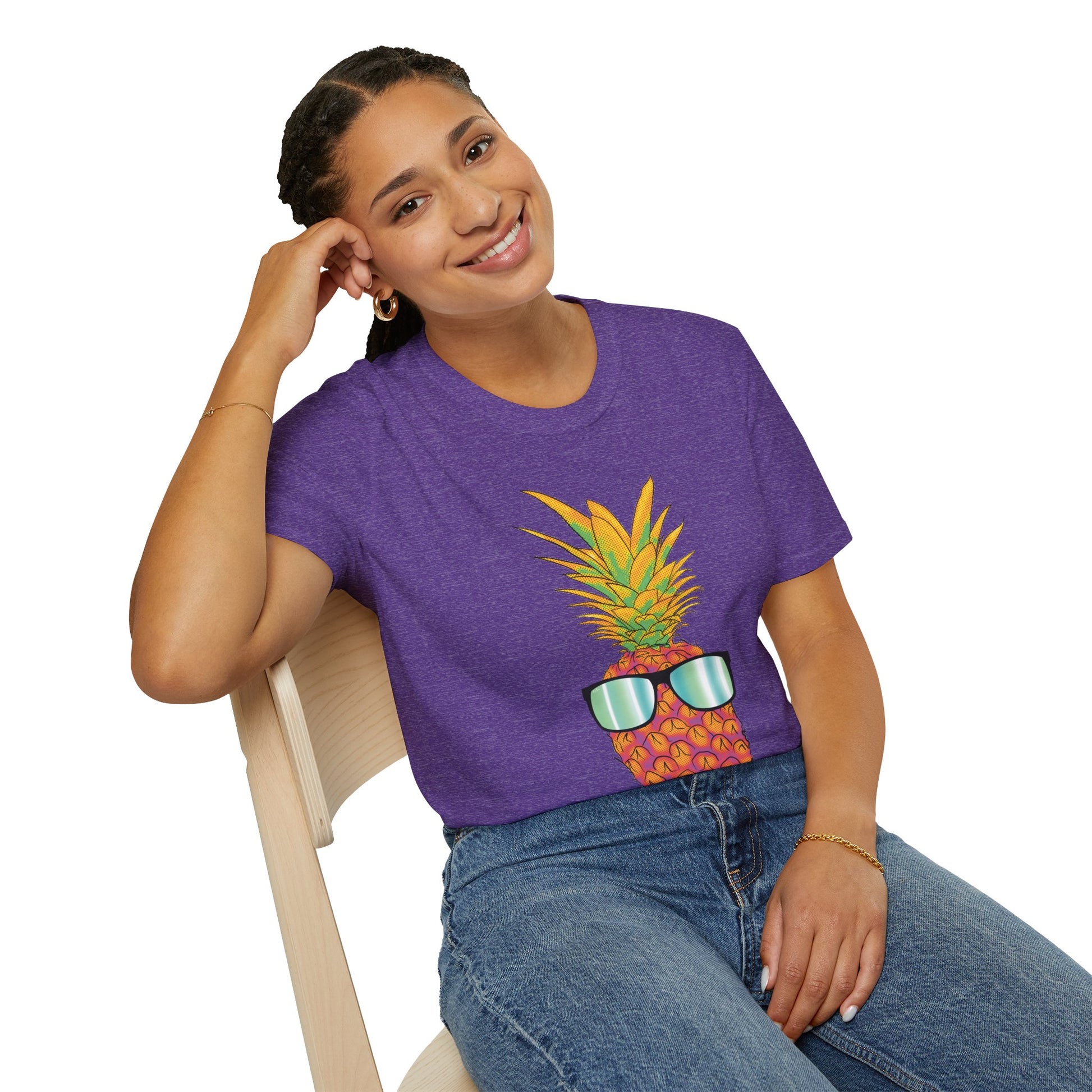 Woman wearing a purple t-shirt featuring a drawing of a pineapple wearing sunglasses.