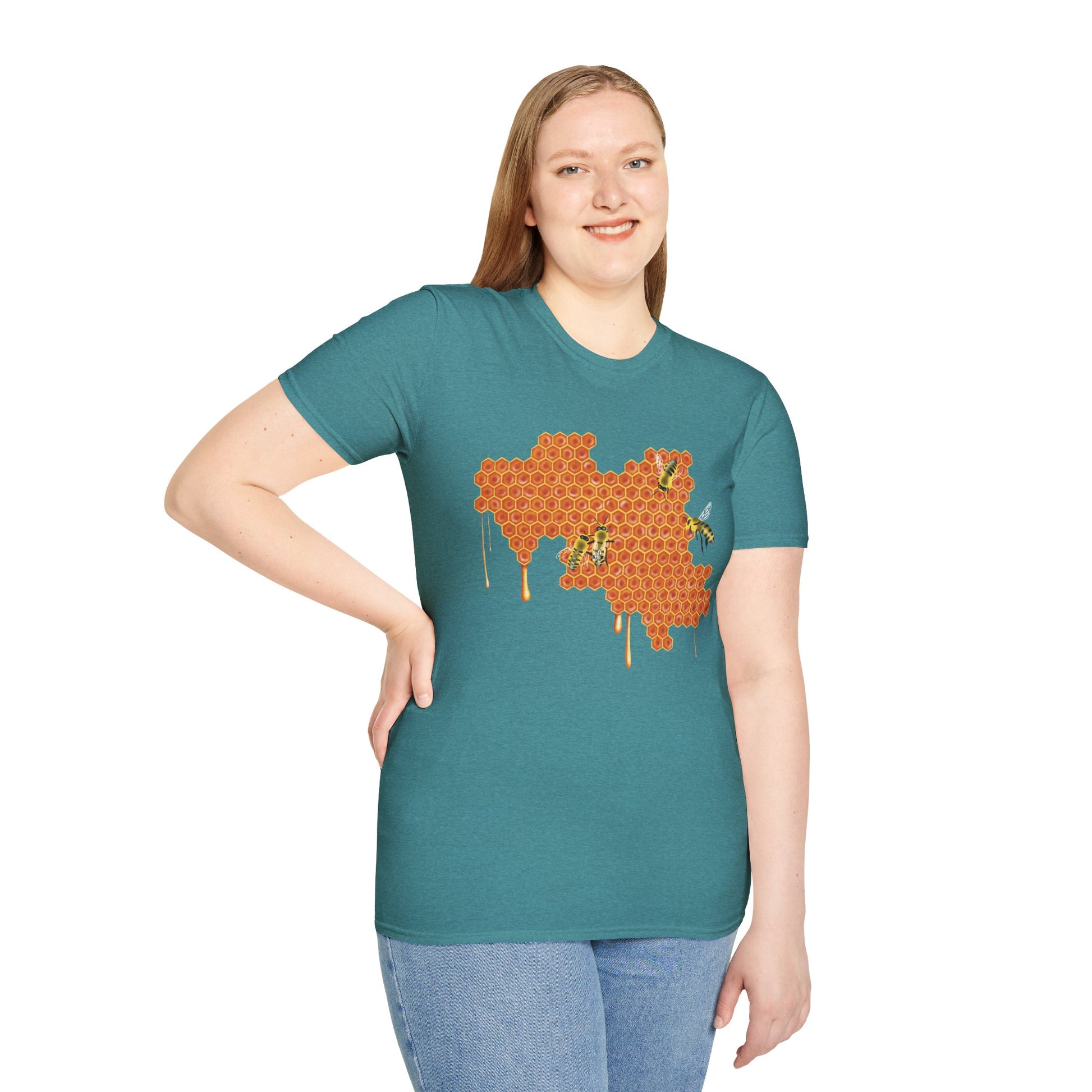 Woman wearing a blue shirt featuring a picture of honeybees buzzing around a large piece of honeycomb with honey dripping down from it.