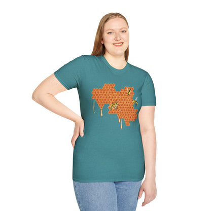 Woman wearing a blue shirt featuring a picture of honeybees buzzing around a large piece of honeycomb with honey dripping down from it.