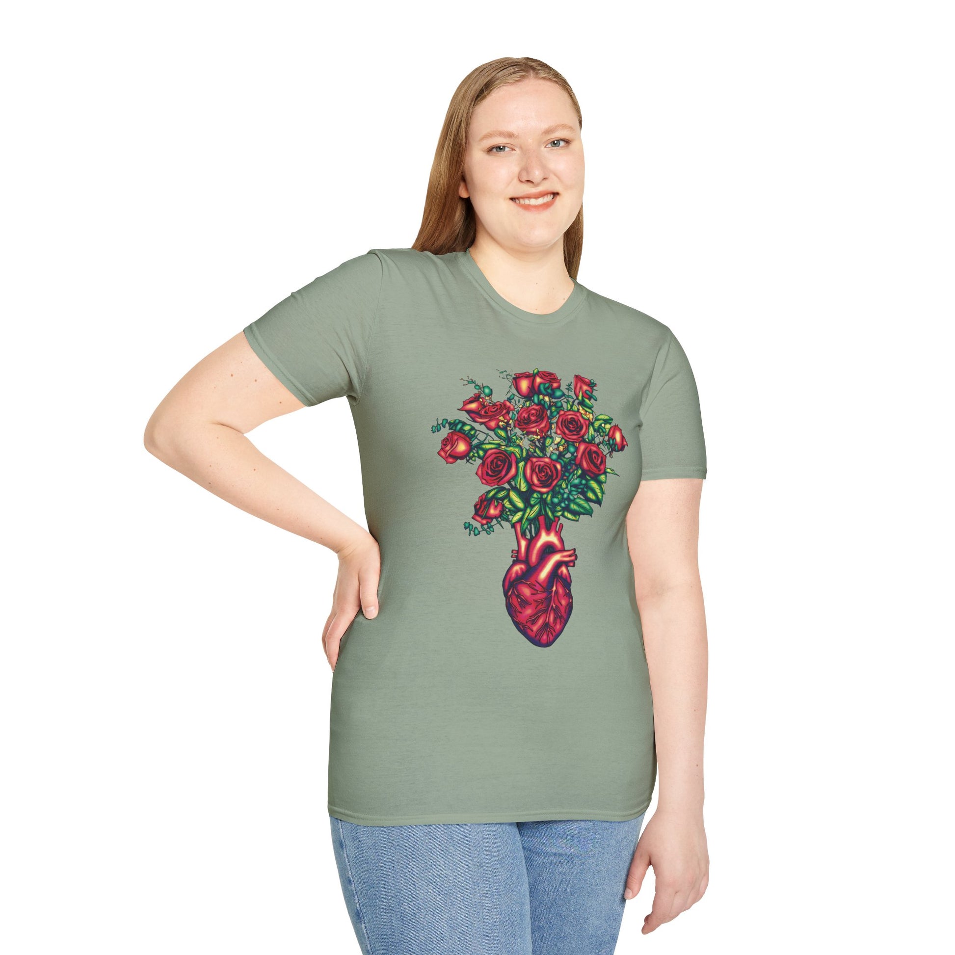 Woman wearing a light green shirt featuring an illustration of an anatomical heart used as a vase, with a bouquet of roses emerging from it.