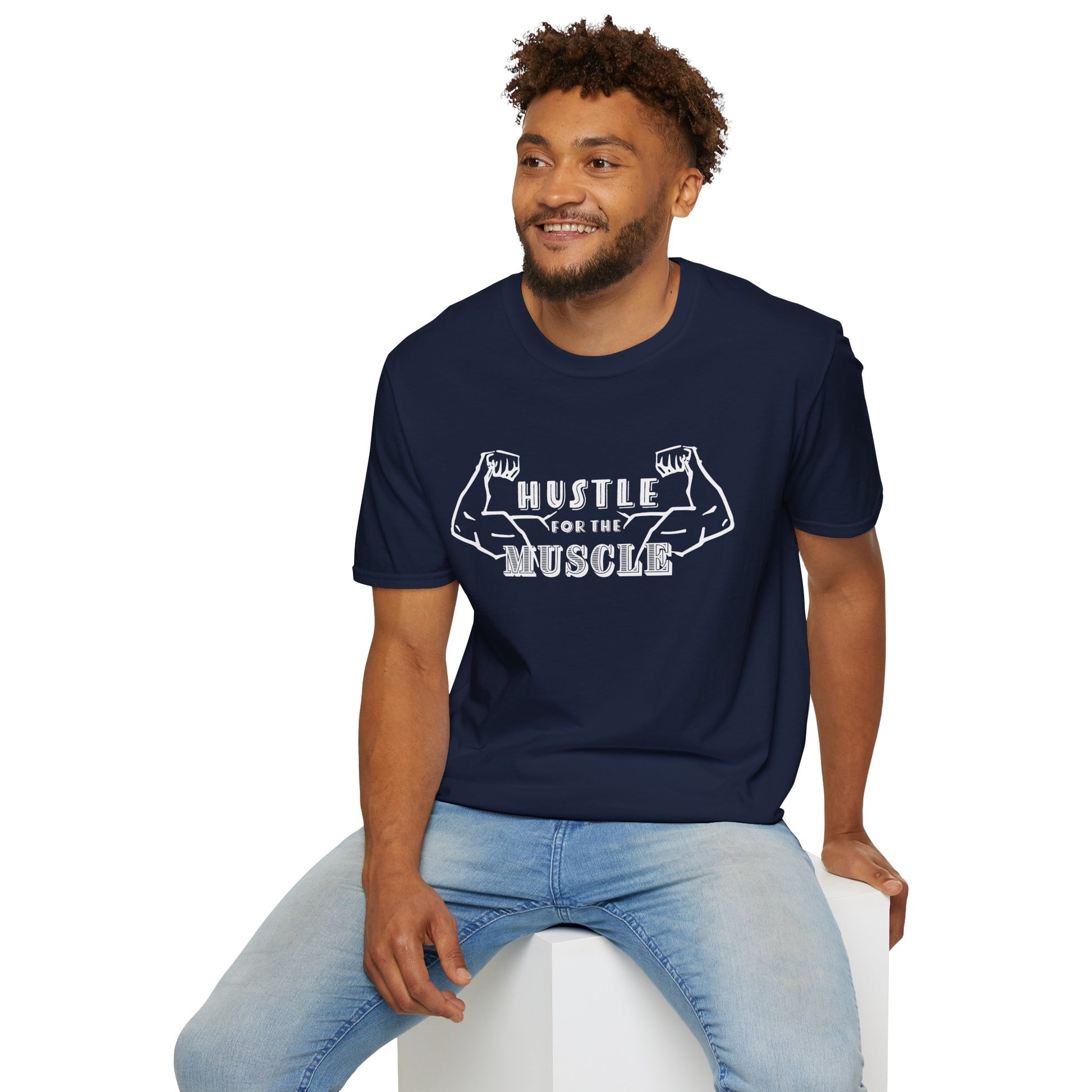 Man wearing a navy unisex short sleeve t-shirt featuring a pair of flexed, muscle-bound arms and the bold text "Hustle for the Muscle"—because gains don’t come from wishes, they come from reps.