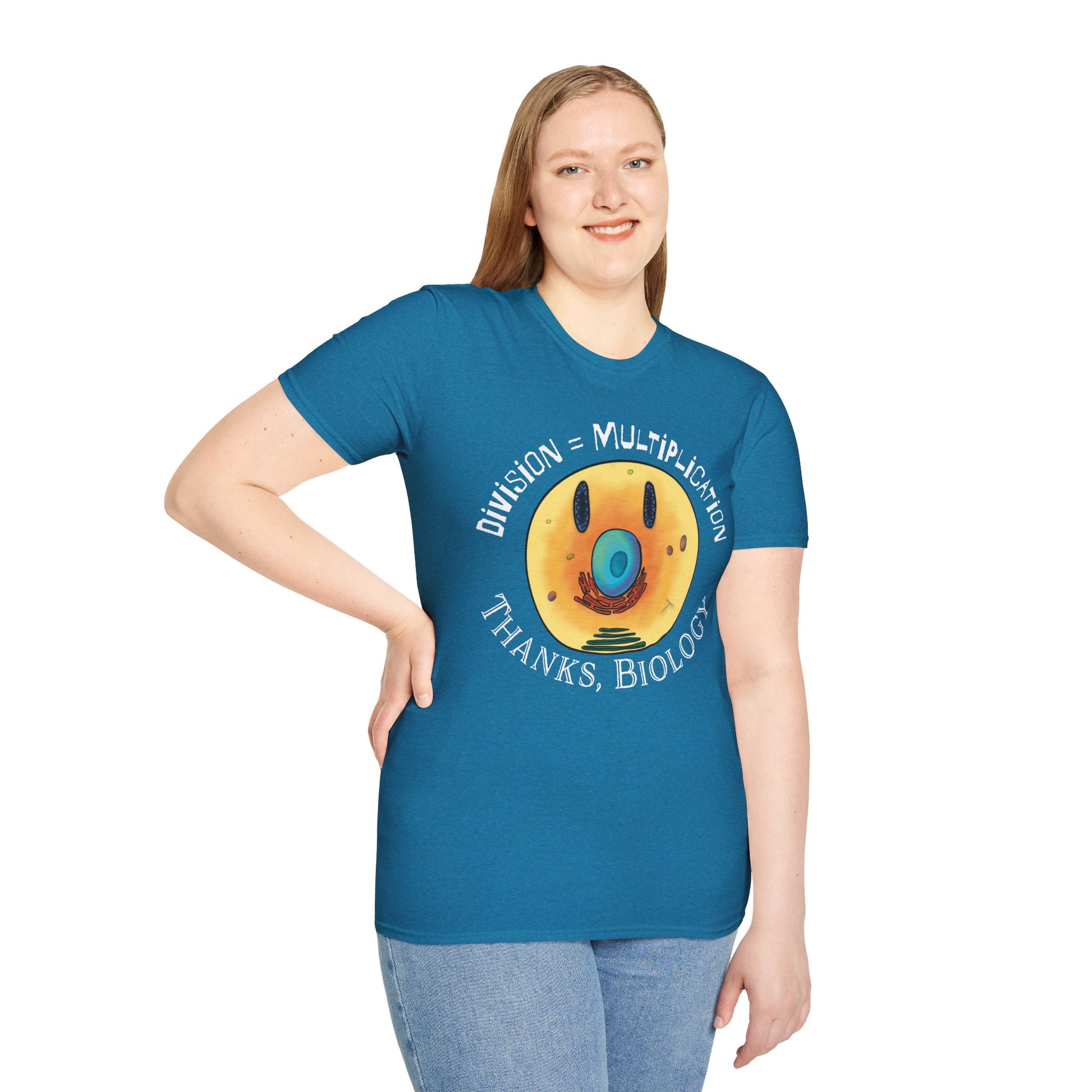Woman wearing a light blue t-shirt featuring an illustration of a cell, with cellular organelles arranged to create a smiley face. The text 'Division = Multiplication. Thanks, Biology' is displayed surrounding the image.