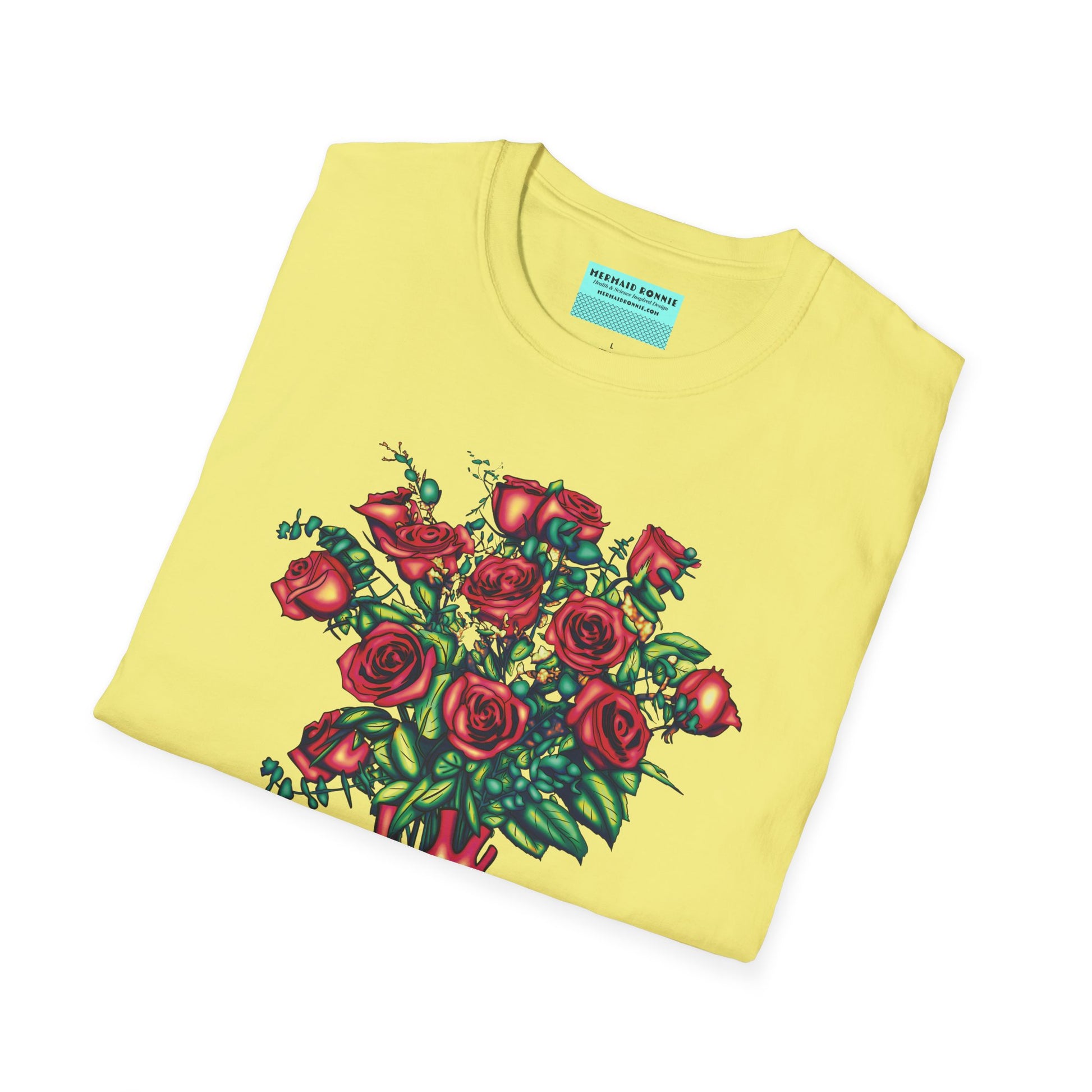 Folded yellow shirt featuring an illustration of an anatomical heart used as a vase, with a bouquet of roses emerging from it.