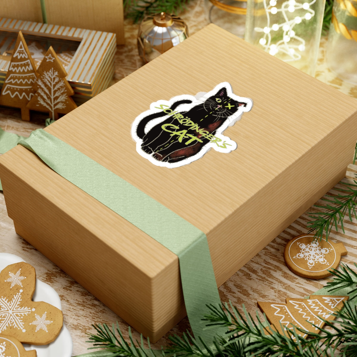 Medium sticker adhered to a gift featuring a black cat with one half depicted as alive and the other half as dead, with an X over one eye, representing Schrödinger's cat.