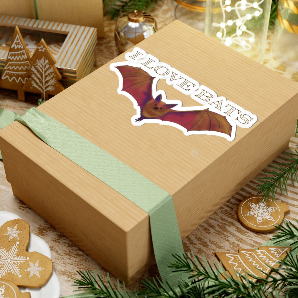 Large sticker featuring a drawing of a brown bat in flight with text that says 'I love bats.' The sticker is adhered to a gift