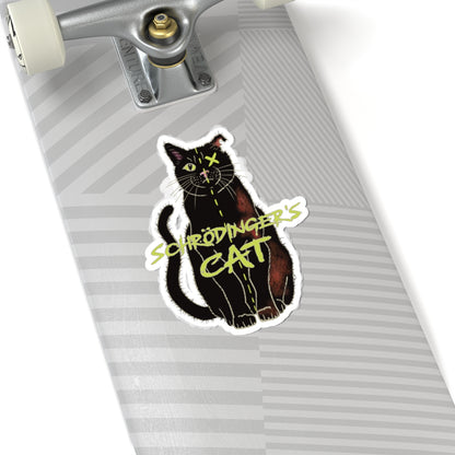 Large sticker adhered to a skateboard featuring a black cat with one half depicted as alive and the other half as dead, with an X over one eye, representing Schrödinger's cat.