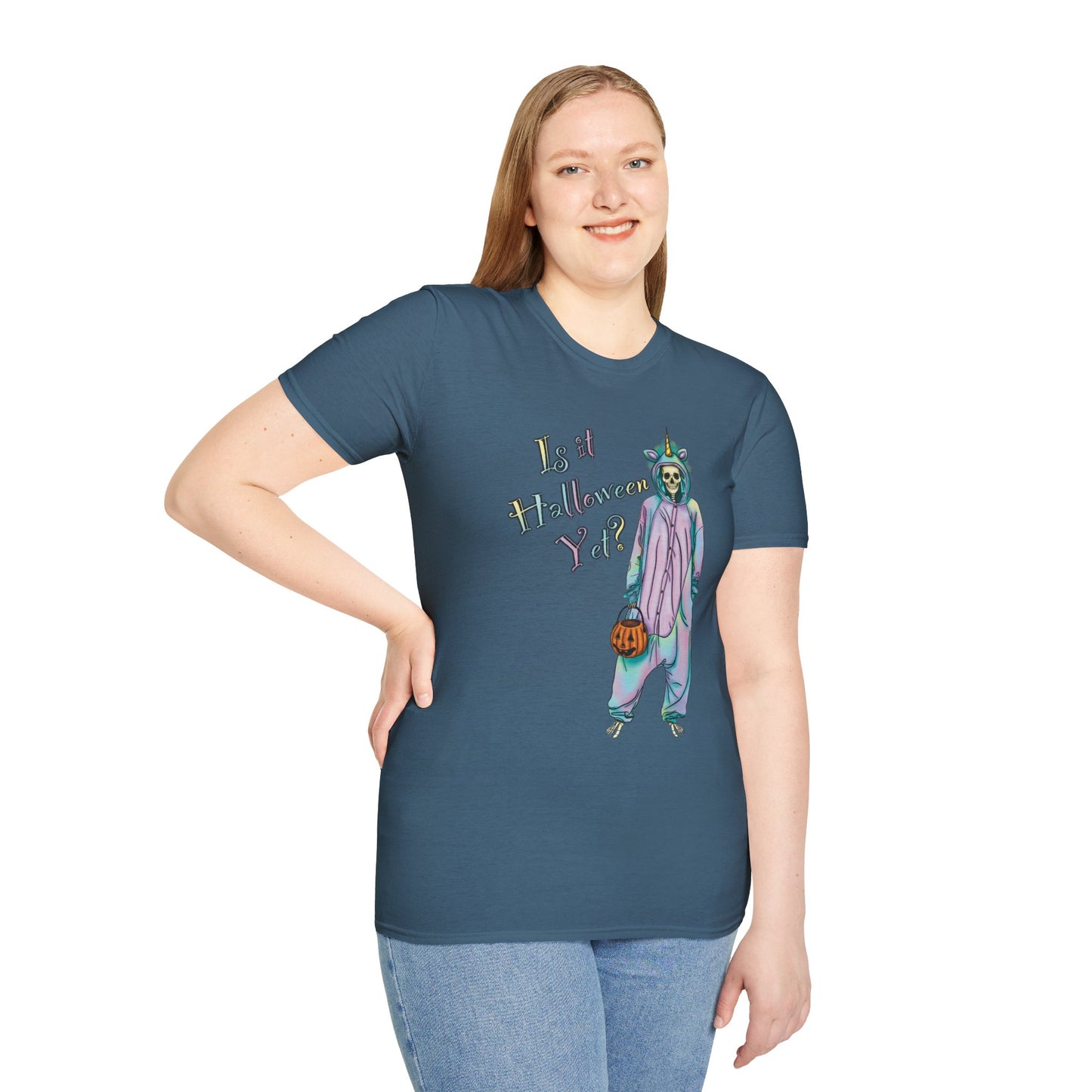 Woman wearing a blue t-shirt featuring a drawing of a skeleton in a unicorn costume onesie, with the phrase 'Is it Halloween yet?' printed on it.