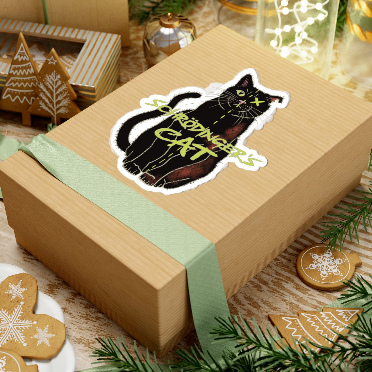 Large sticker adhered to a gift featuring a black cat with one half depicted as alive and the other half as dead, with an X over one eye, representing Schrödinger's cat.