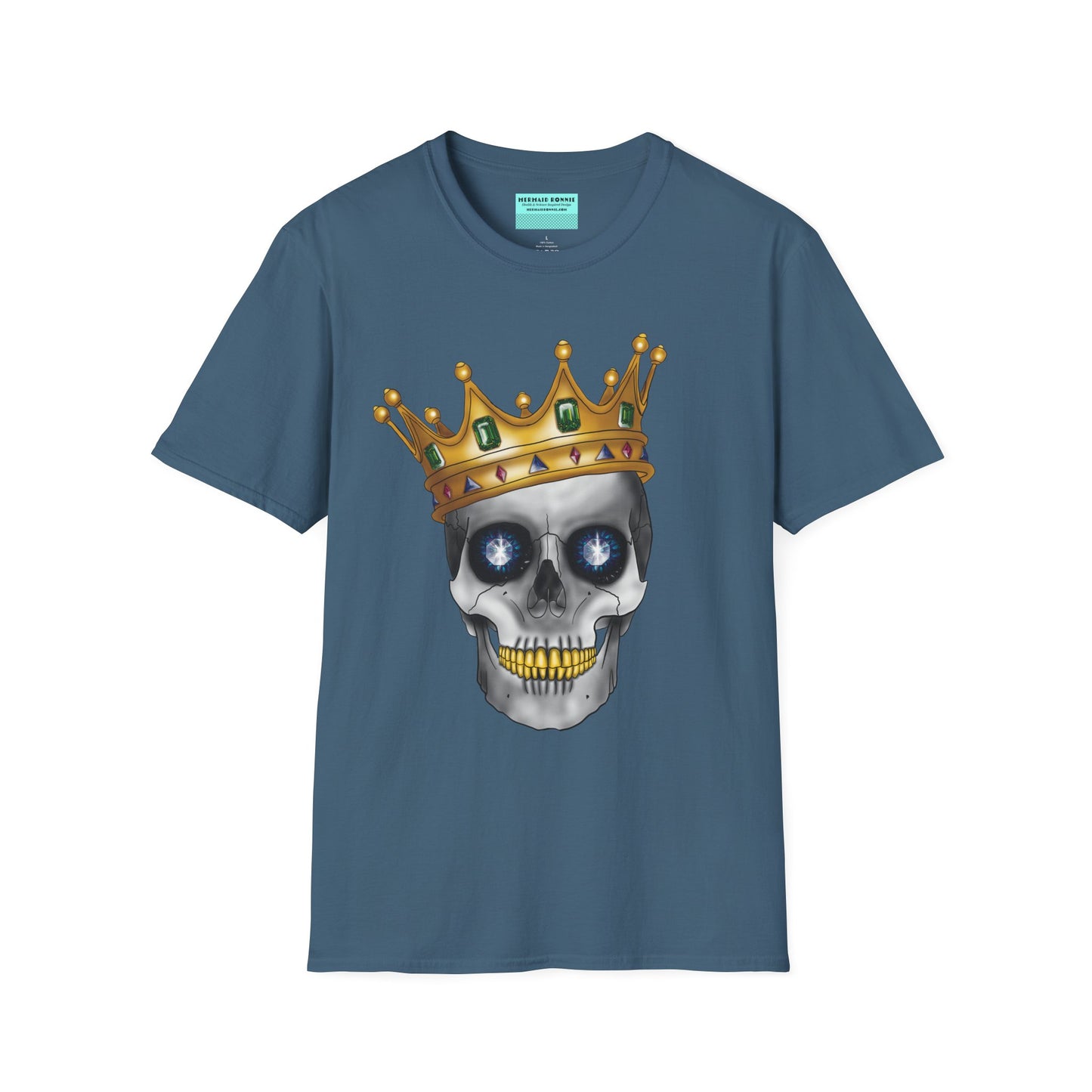 Indigo blue t-shirt featuring an anatomical skull wearing an ornate crown, with gold teeth, large sapphire gemstones in the eye sockets, and emeralds and rubies decorating the crown.