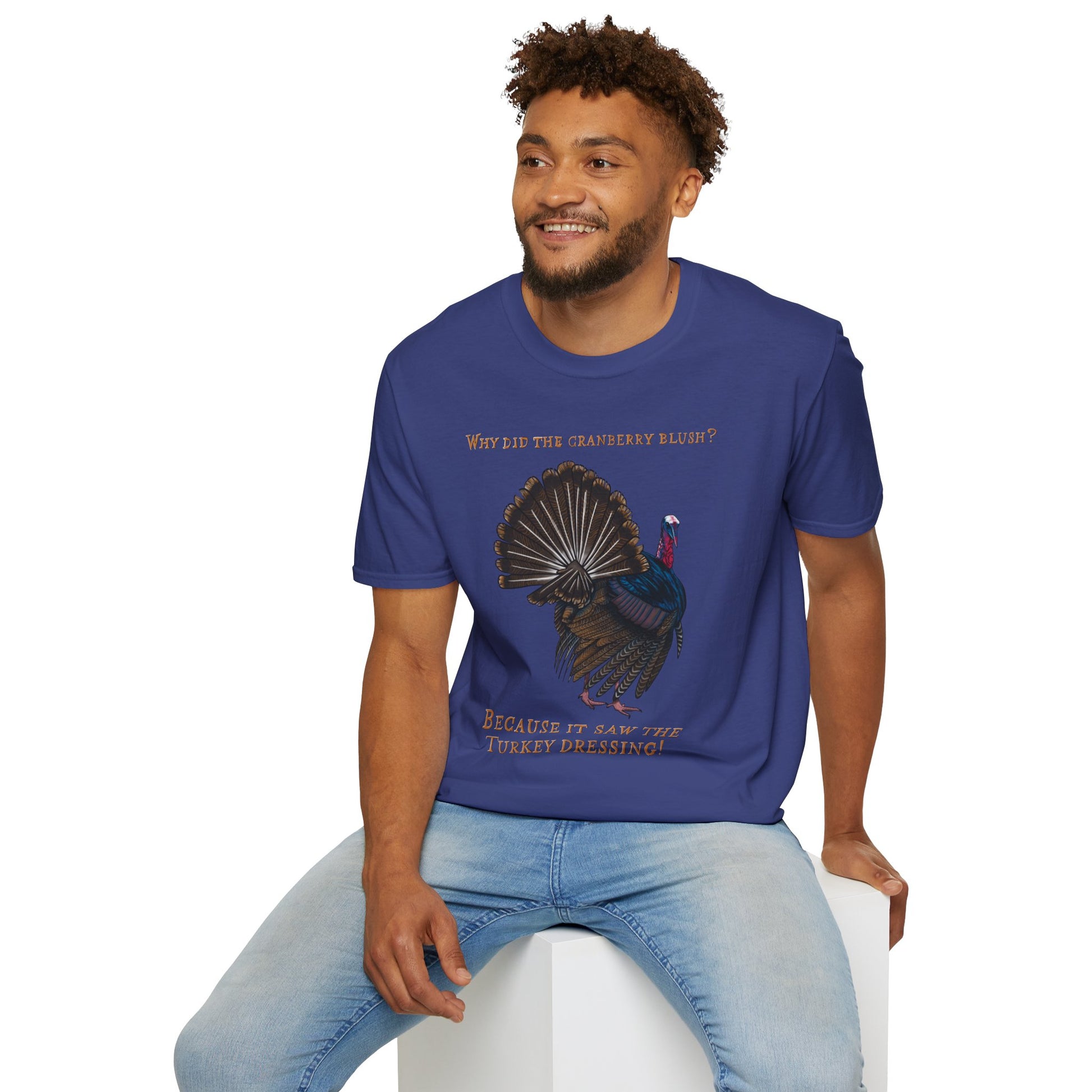 Man wearing a blue Thanksgiving t-shirt featuring a picture of a turkey and the text 'Why did the cranberry blush? Because it saw the turkey dressing!