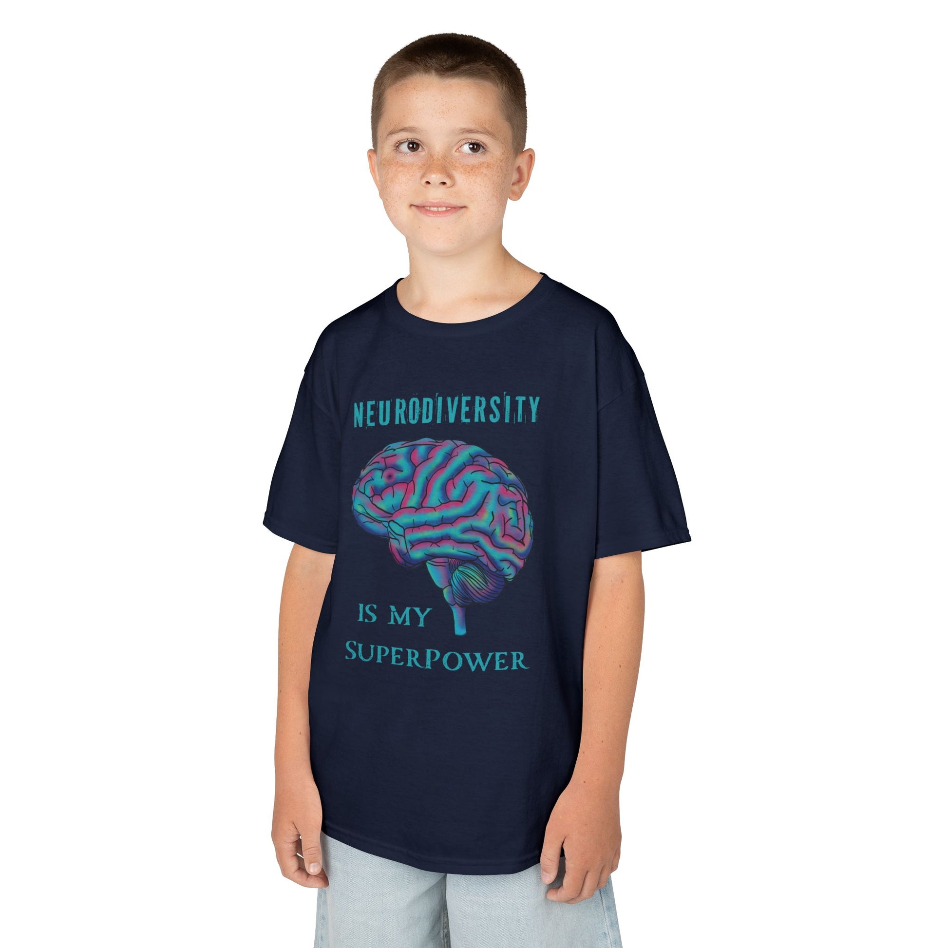 Boy is wearing a navy unisex kids' t-shirt featuring a drawing of an anatomical brain and the text 'Neurodiversity is my superpower.'