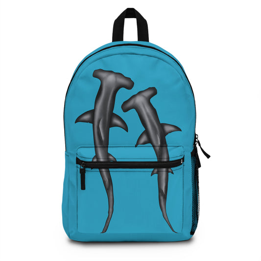 Turquoise blue backpack featuring a dynamic duo of hammerhead sharks gliding across the front—because nothing says "ready to tackle the day" like marine muscle and cartilaginous cool.