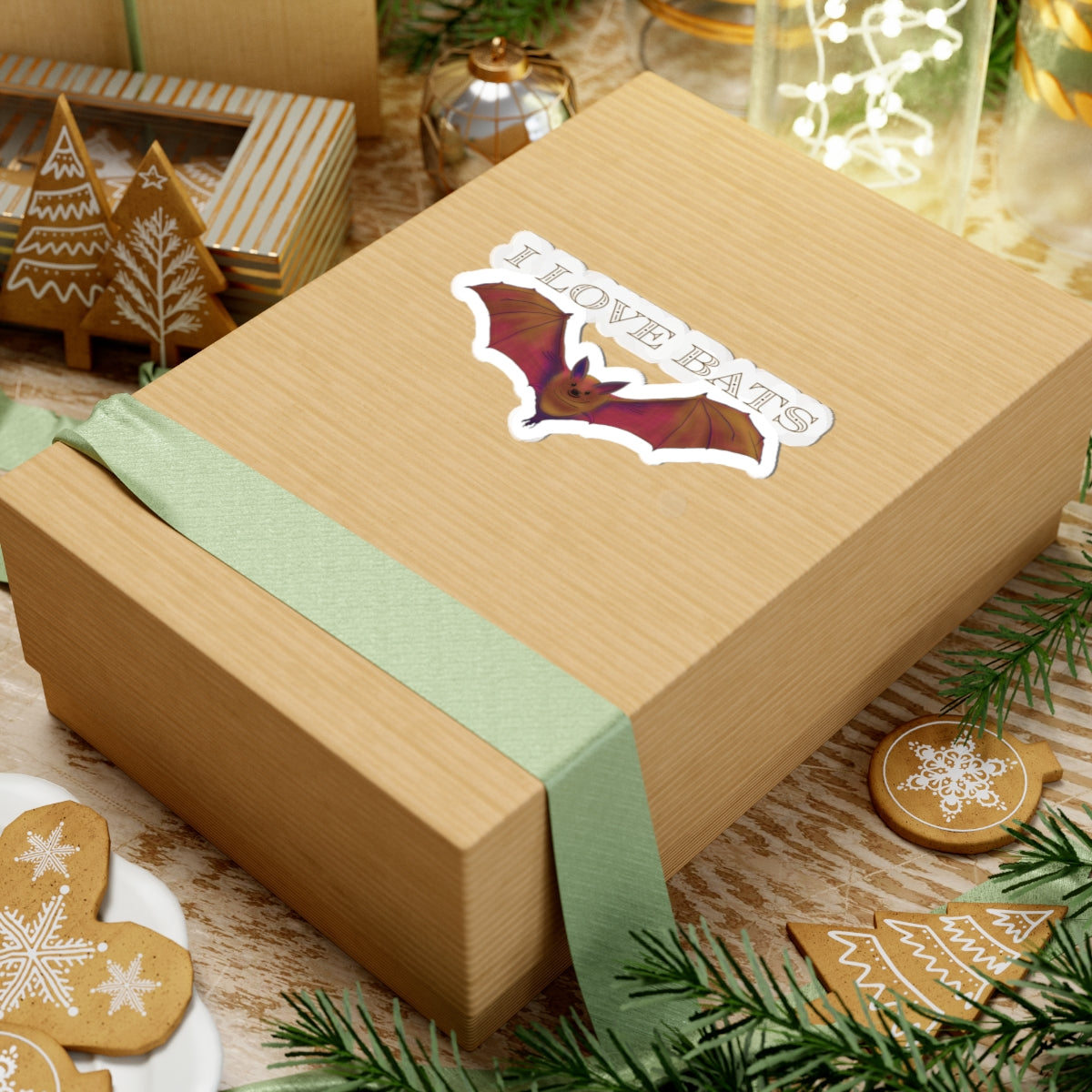Medium sticker featuring a drawing of a brown bat in flight with text that says 'I love bats.' The sticker is adhered to a gift