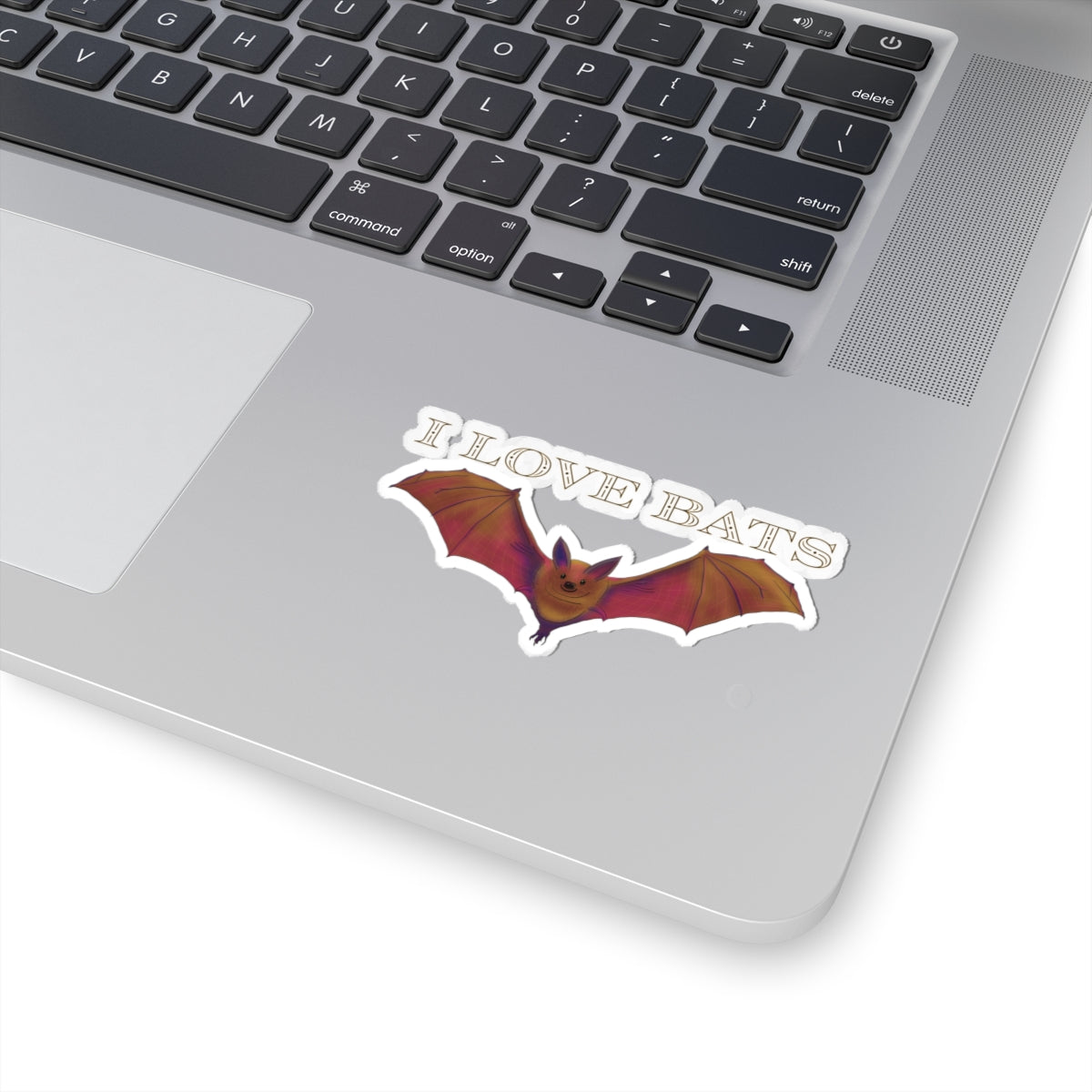 Small sticker featuring a drawing of a brown bat in flight with text that says 'I love bats.' The sticker is adhered to a computer